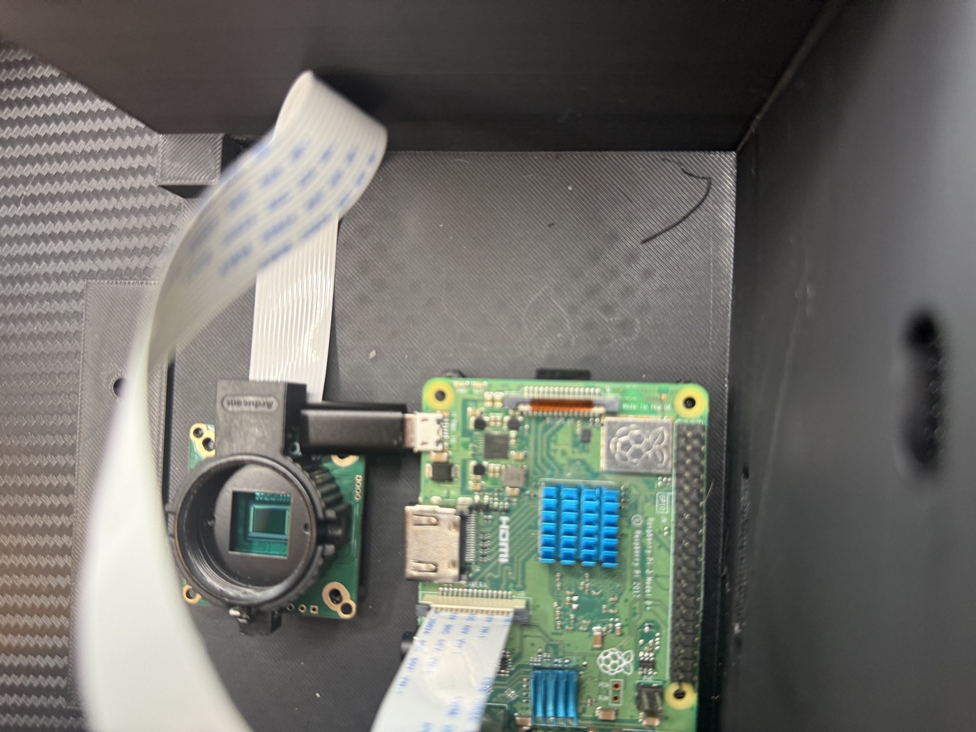 Top-down view inside the v2 printed enclosure showing where the camera and Pi don't fit together cleanly